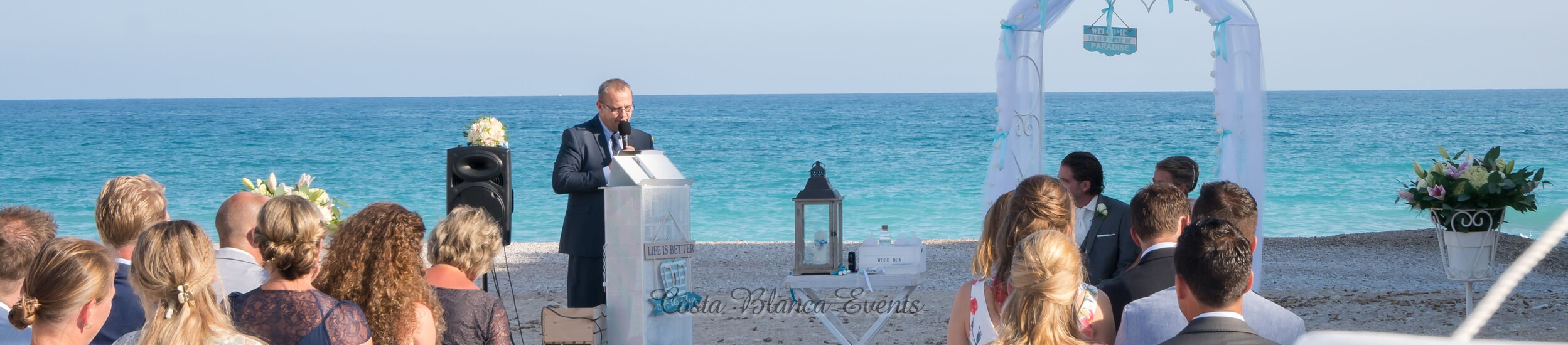 Photo of a ceremony of a couple getting married in Spain on the beach